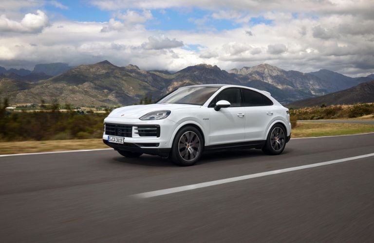 One white color 2023 Porsche Cayenne is running on the road.