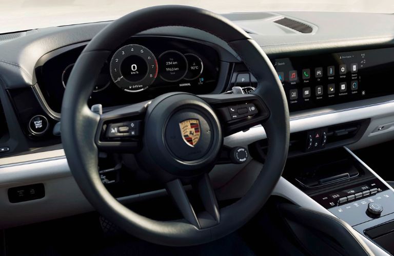 The steering wheel of the 2023 Porsche Cayenne is shown.